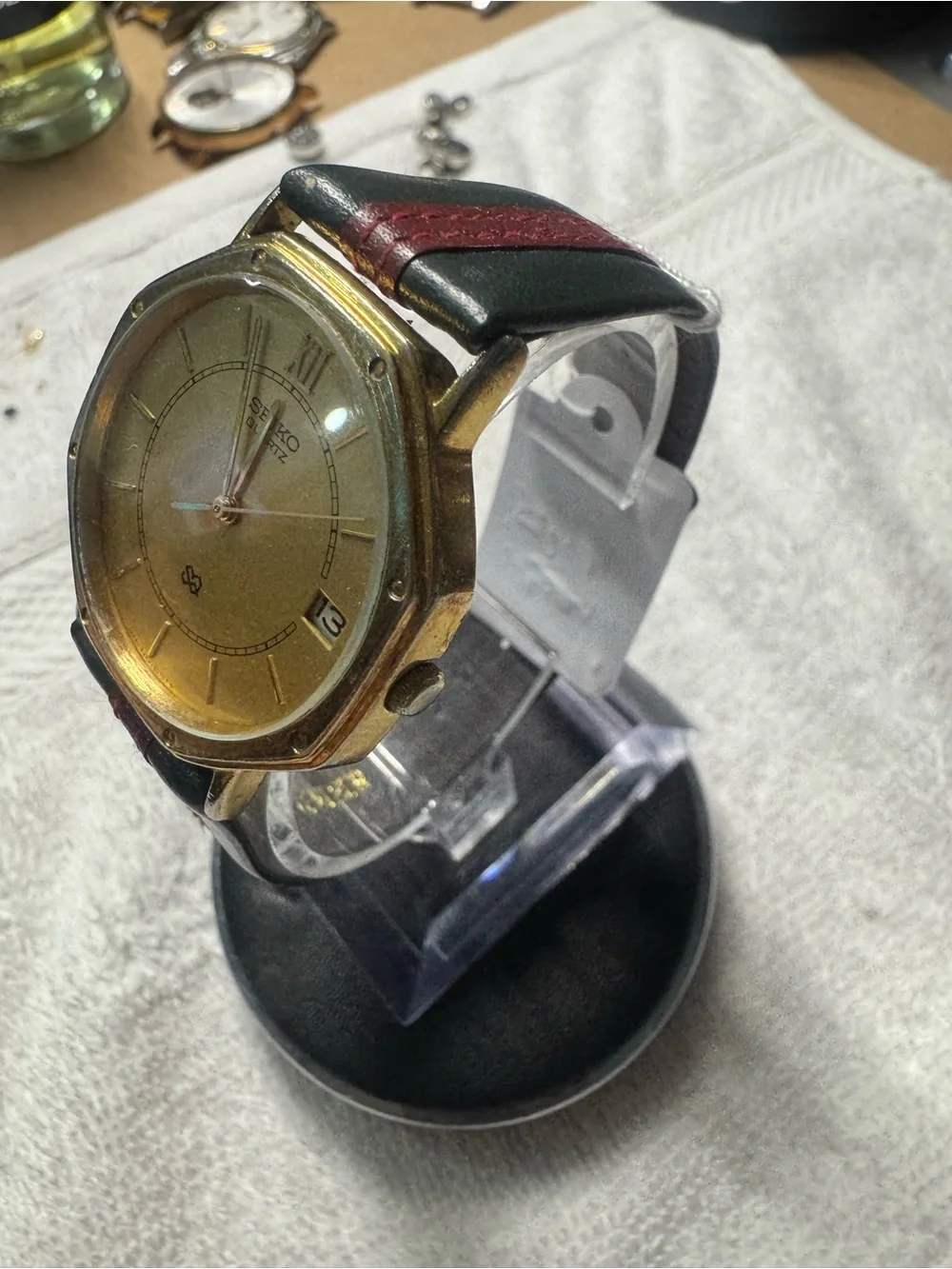Seiko Gold Dial Watch with Black Strap and Red Stitch